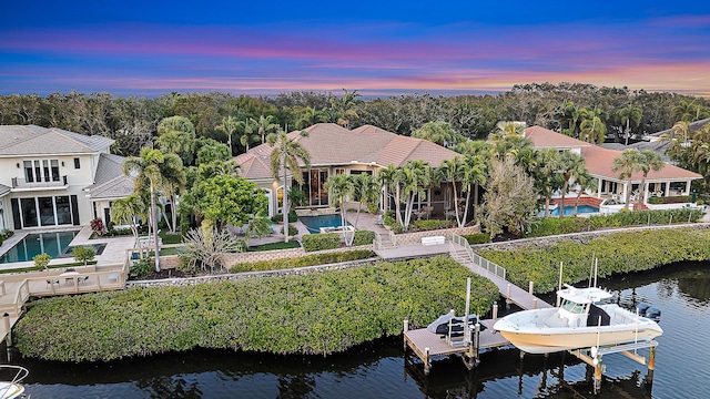 aerial view at dusk with a water view