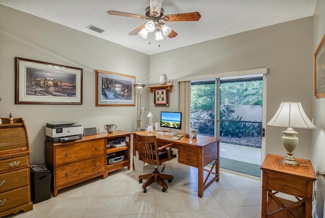 tiled home office featuring ceiling fan and a textured ceiling