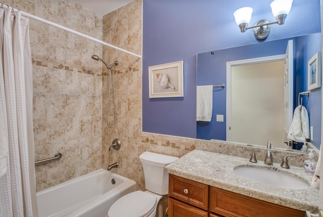 full bathroom with shower / bath combination with curtain, vanity, toilet, and tile walls