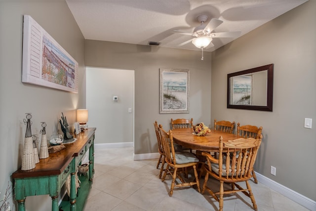 tiled dining area featuring ceiling fan and a textured ceiling