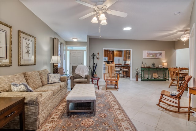 living room featuring ceiling fan and light tile patterned floors