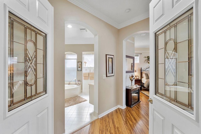 hall featuring light hardwood / wood-style flooring and ornamental molding