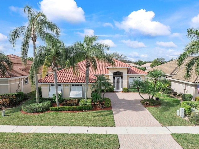 mediterranean / spanish home with a front yard