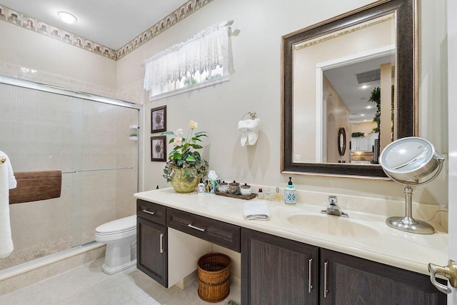 bathroom featuring tile patterned flooring, vanity, an enclosed shower, and toilet