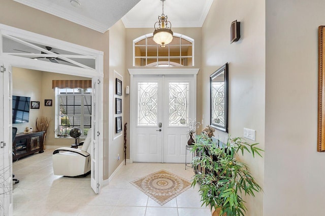 foyer entrance featuring ceiling fan, crown molding, light tile patterned floors, and a textured ceiling