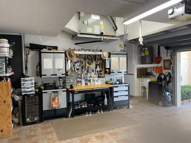 garage with a workshop area, water heater, and a garage door opener