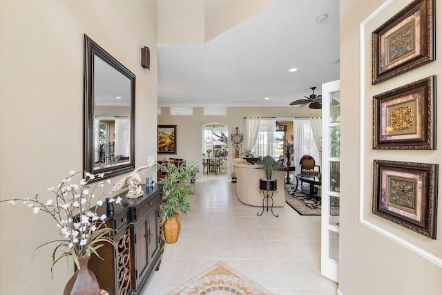 hallway featuring light tile patterned floors and a textured ceiling