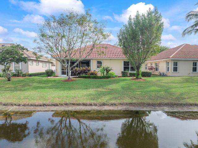 back of property featuring a yard and a water view