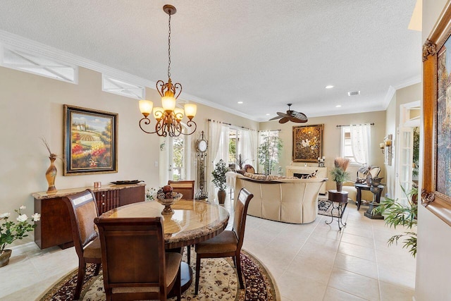 dining space featuring crown molding, light tile patterned floors, ceiling fan with notable chandelier, and a textured ceiling