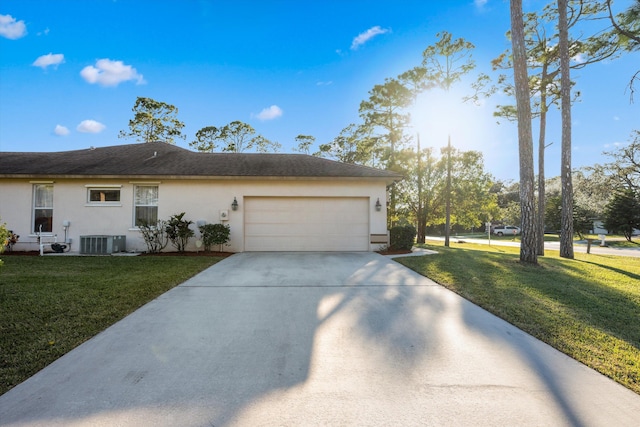 view of front facade featuring central AC, a front lawn, and a garage