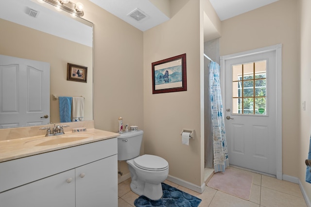 bathroom with toilet, vanity, tile patterned flooring, and a shower with shower curtain