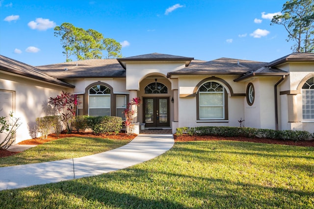 view of front of home featuring a front yard and french doors