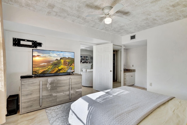 bedroom featuring ensuite bath and ceiling fan