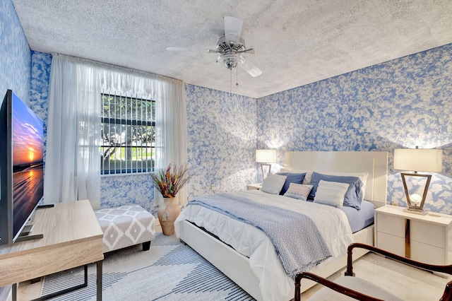 bedroom featuring a textured ceiling and ceiling fan