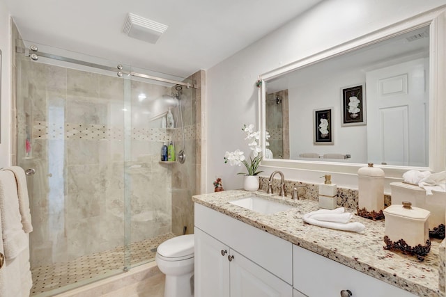 bathroom with vanity, toilet, and an enclosed shower