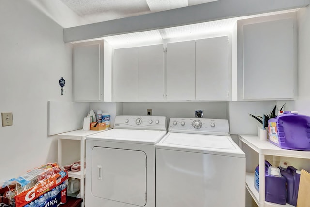 washroom featuring cabinets and independent washer and dryer