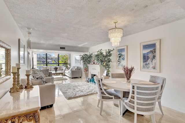 dining room featuring a textured ceiling and an inviting chandelier