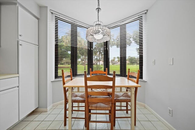 tiled dining room featuring an inviting chandelier