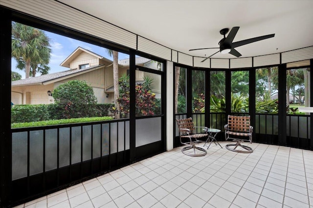 sunroom / solarium featuring ceiling fan and plenty of natural light