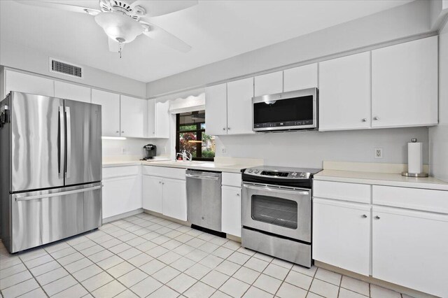 kitchen with ceiling fan, white cabinets, and stainless steel appliances