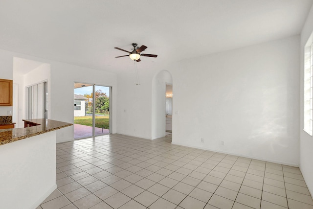 unfurnished living room with ceiling fan and light tile patterned flooring