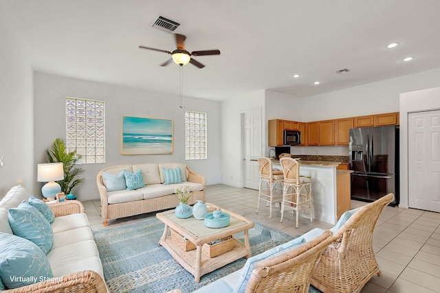 tiled living room with ceiling fan