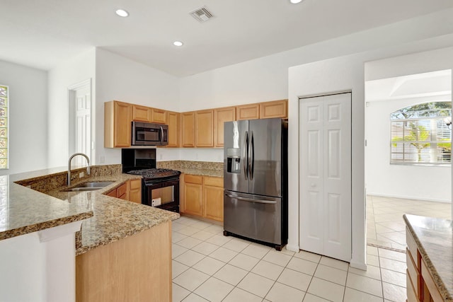 kitchen with kitchen peninsula, light tile patterned floors, stainless steel appliances, and sink