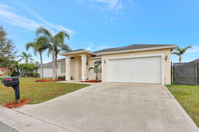 view of front of home with a front yard and a garage