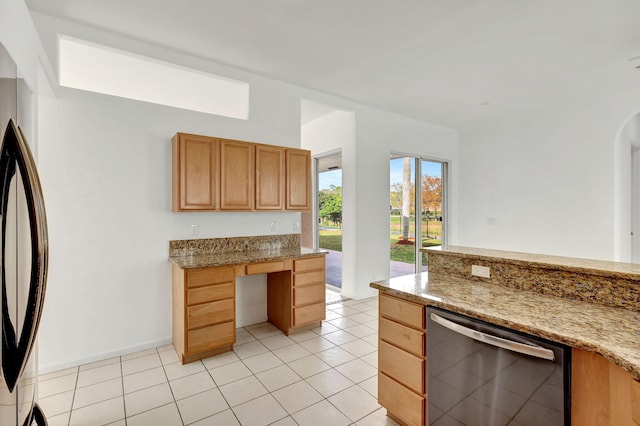 kitchen with dishwasher, refrigerator, light stone countertops, and light tile patterned flooring