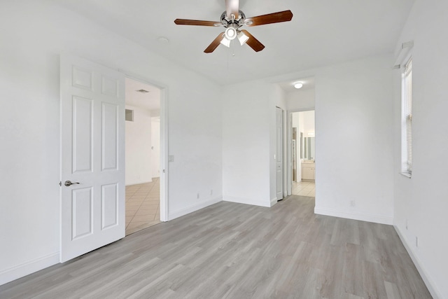 empty room with ceiling fan and light wood-type flooring