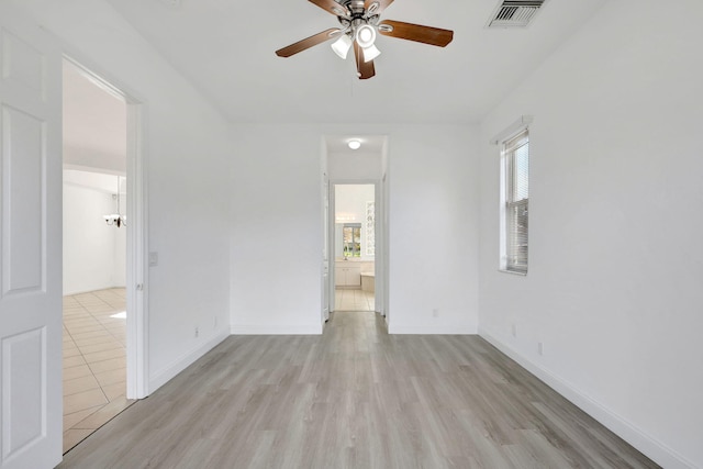 spare room with light wood-type flooring and ceiling fan