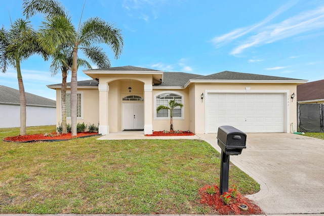 view of front facade featuring a garage and a front lawn