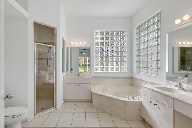 full bathroom with tile patterned floors, vanity, separate shower and tub, ceiling fan, and toilet