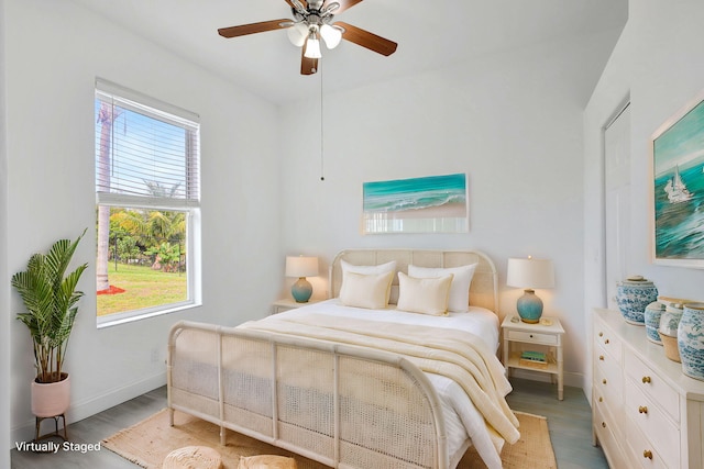 bedroom with light hardwood / wood-style flooring and ceiling fan