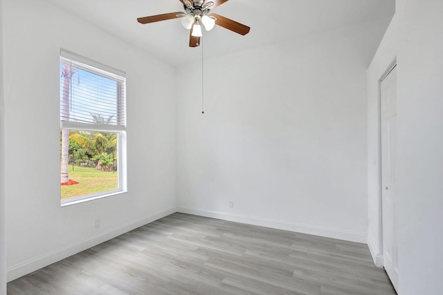 spare room featuring light wood-type flooring and ceiling fan