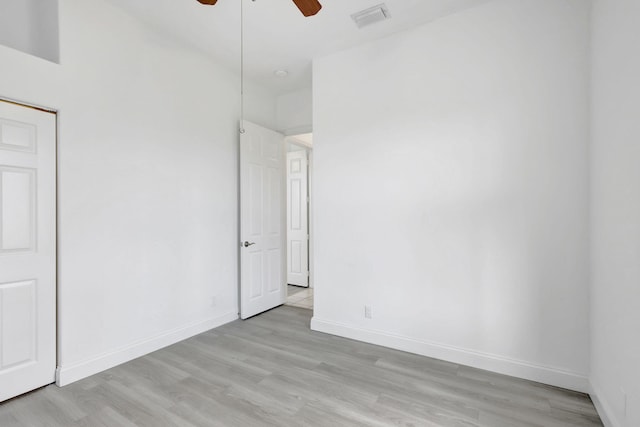 empty room featuring ceiling fan and light wood-type flooring