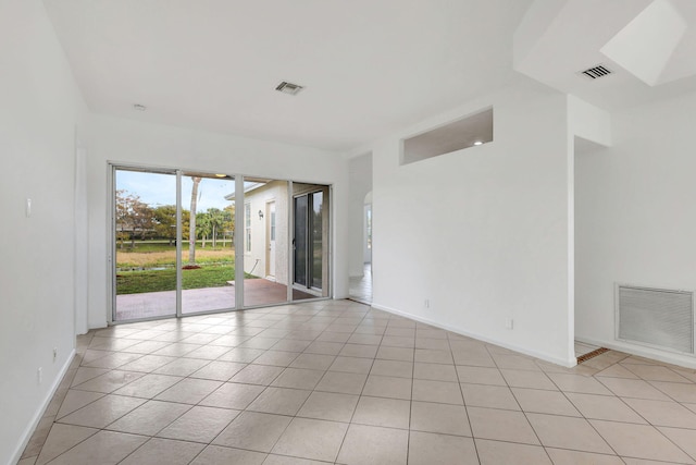 spare room featuring light tile patterned flooring