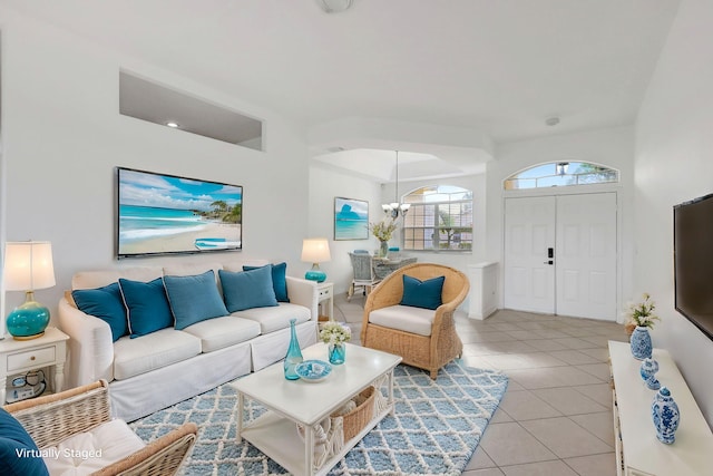 tiled living room featuring an inviting chandelier