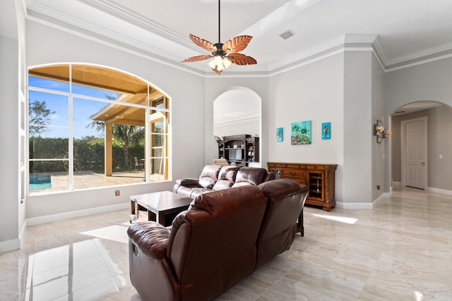 living room with ceiling fan and ornamental molding