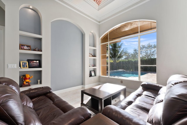 living room with built in features and ornamental molding