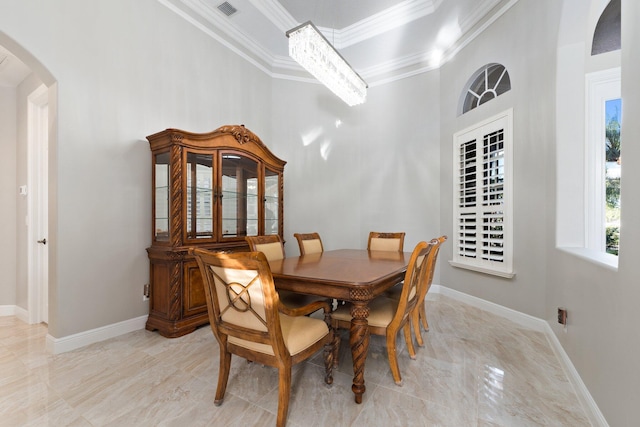 dining area featuring crown molding