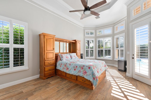 bedroom featuring ceiling fan, light wood-type flooring, ornamental molding, and access to outside