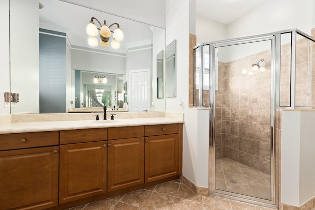 bathroom featuring tile patterned flooring, vanity, a shower with door, and ornamental molding