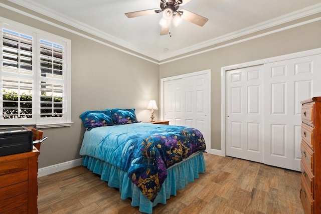 bedroom with hardwood / wood-style flooring, ceiling fan, and crown molding