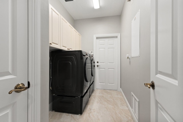 laundry area with cabinets and washer and clothes dryer