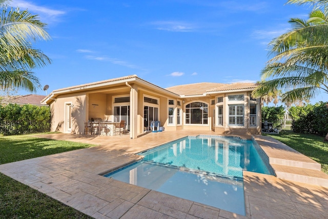 view of pool featuring a patio area, an outdoor bar, and a yard