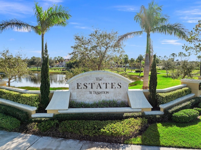 community / neighborhood sign featuring a water view