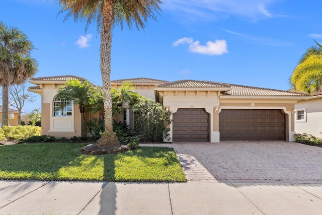 mediterranean / spanish-style home with a garage and a front yard