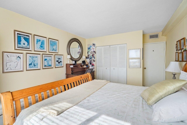 bedroom with a textured ceiling and a closet