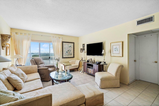 living room featuring light tile patterned floors and a textured ceiling